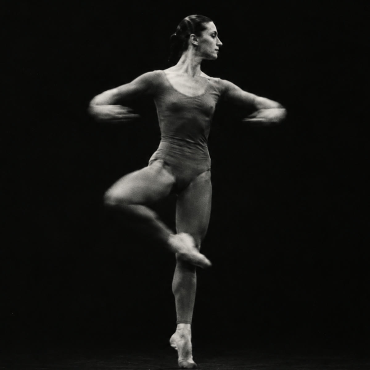 Dancer mid-pirouette, arms blurred